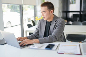 Asian Business man working with laptop. Young business man thinking Concentrated at work.