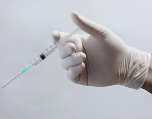 doctor in a medical mask with a syringe on a black background.