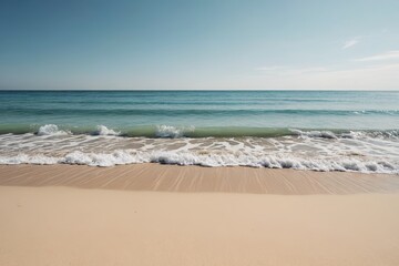 there is a wave coming in to the beach with a blue sky