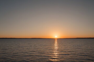 arafed view of a sunset over a body of water