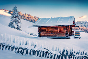 Untouched winter landscape. Wooden chalet on the hill of Alpe di Siusi village. Exciting winter...