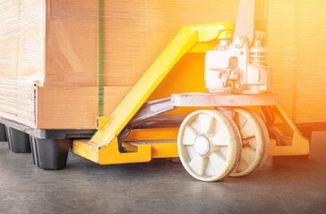 Hand Pallet Truck and pallet of Package Boxes. Pallet Jack Forklift Loader, Hand Lift. Warehouse Work Tools.	
