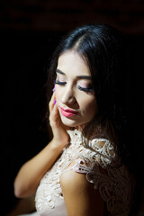 Portrait of a beautiful girl in a dark room