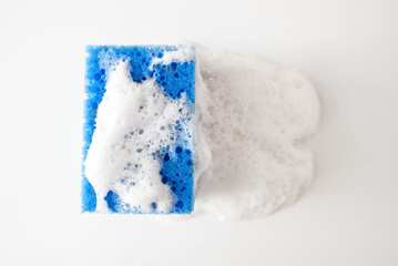 Soapy dishwashing sponge full of white foam, isolated on white background