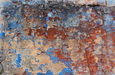 Old grunge wall with blue and red paint. Abstract background for design.