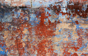 Old grunge wall with blue and red paint. Abstract background for design.
