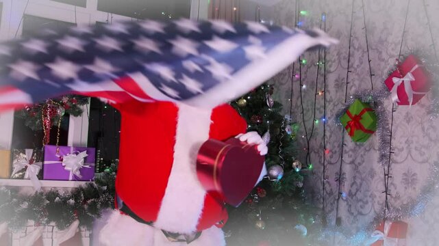 Santa dancing with the US flag holding a heart shaped gift box standing against the backdrop of a festive room decorated with a Christmas tree, garlands, and New Year's balls.