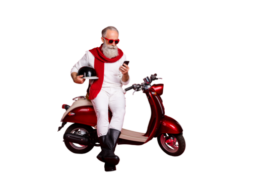 Aged macho man sit on retro moped chatting telephone wear jumper and trousers isolated red background