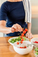 Close up of womans hands holding cherry tomatoes