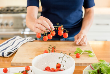 Womans hands holding cherry tomatoes