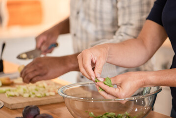 Womans hands breaking lettuce a part