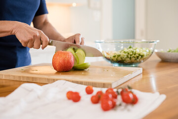 Chopping apples on a cutting board in the kitchen