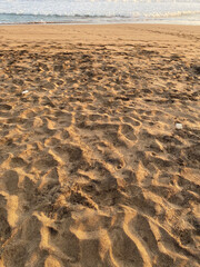 beach sand with many traces of people who have visited