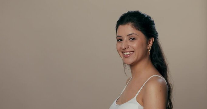 Young girl looking in profile first, then turning to face the camera with a direct and engaging gaze.