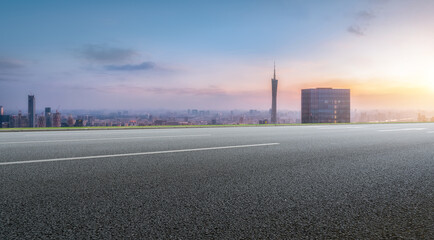 Scenic Urban Sunset with Open Highway and City Skyline