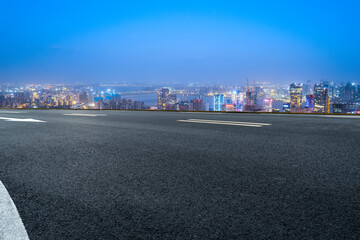 Stunning Urban Nightscape Featuring a Quiet Road and City Lights