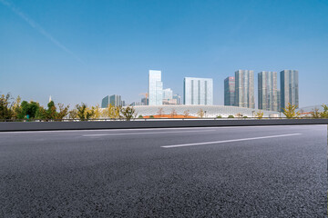 Modern Urban Cityscape with Clear Blue Sky and Open Road