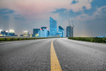 Scenic Urban Highway Leading to a Modern City Skyline at Dusk