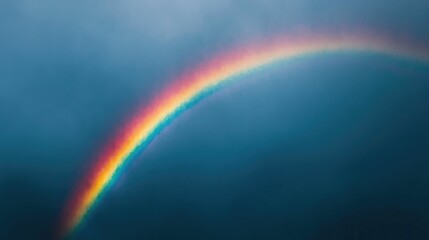 Majestic rainbow arching across a dramatic cloudy sky after a rainstorm creating a vibrant and colorful weather phenomenon with a deep depth of field