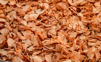 Dried apple slices. Many dried apple slices lie on a white surface. Dried fruits. Organic food.	
