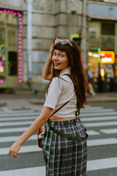 Smiling young woman in the city.
