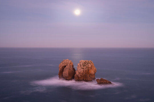 Fullmoon over Urro del Manzano rock formation, Liencres, Spain