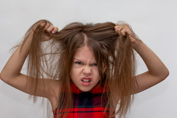 Child pulling her hair as concept of autoaggression