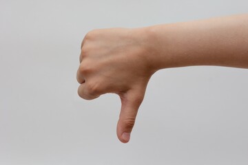 Child thumb down on white background