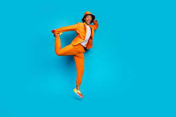 Obraz premium Full length photo of positive gut jumping moving touch legs wear stylish outfit isolated cyan color background