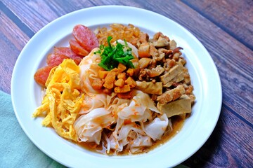Chinese steamed rice noodles with pork, tofu, squid, egg, Shiitake mushrooms, Chinese sausage.