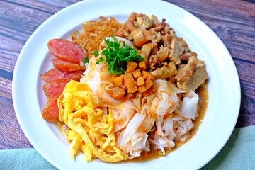 Chinese steamed rice noodles with pork, tofu, squid, egg, Shiitake mushrooms, Chinese sausage.