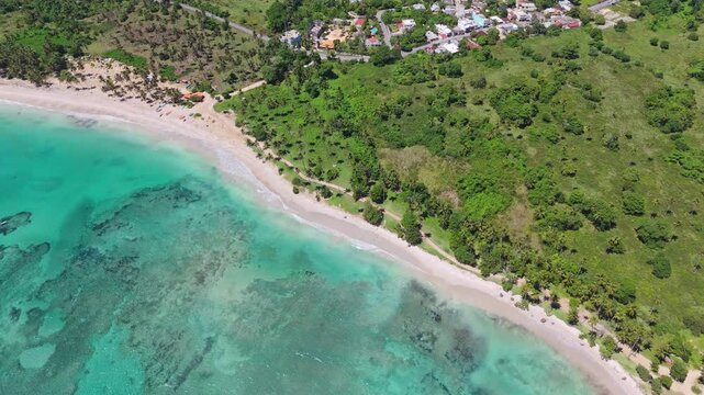 Aerial top down of crystal clear Caribbean Sea water at playa los coquitos. Luxury resort hotel area with palm trees in summer. Cabrera, Dominican Republic.