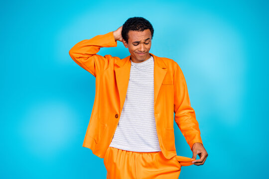 Photo of upset guy look empty pockets pants have no moeny isolated cyan color background