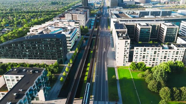 High aerial view over Orestad metro line through green urban area, Copenhagen