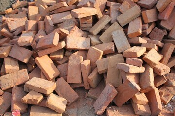 Pile of Red Bricks and Construction Debris at a Building Site