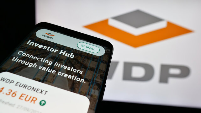 Stuttgart, Germany - 09-29-2024: Smartphone with website of Belgian company Warehouses De Pauw SA (WDP) on screen in front of business logo. Focus on top-left of phone display.