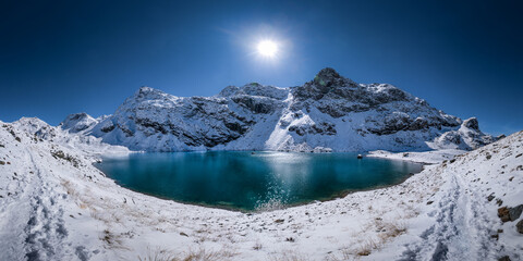 Panoramic view of Lac du Domènon in the french Alps. mountain lake in winter, sunndy day, blue sky