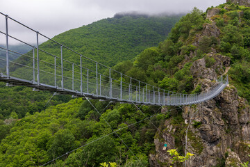 Fototapeta premium Footbridge to the village of Hautpoul near Mazamet. Tarn. Occitanie. France