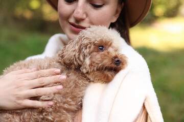 Woman with her cute dog outdoors, closeup