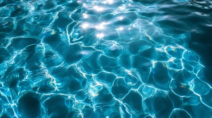 The water is calm and clear, with ripples and waves that reflect the sunlight