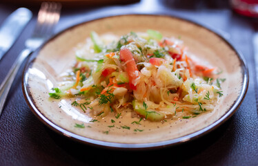 Plate with fresh vegetable salad of tomato, cucumber and celery close up