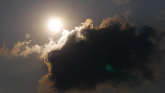 Dark cloud hit by the yellow sunrays and light from the sun.