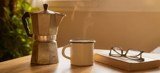 Relaxing Morning by the Window. A Warm Cup of Coffee or Tea, a Coffee Maker, and a Good Book Create the Ideal Atmosphere for a  Start to the Day.