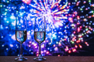 A Pair Of Champagne Glasses With Fireworks In The Background, Signifying Celebration And Luxury For...