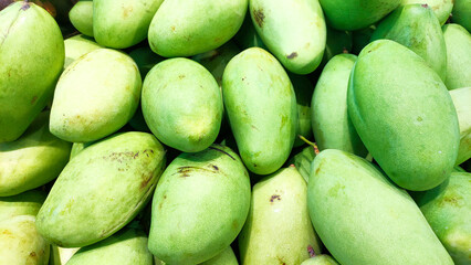 Green mangoes are beautifully arranged in a Thai supermarket.