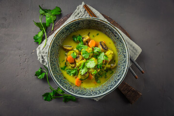 Green curry vegetable soup with mushrooms and cilantro