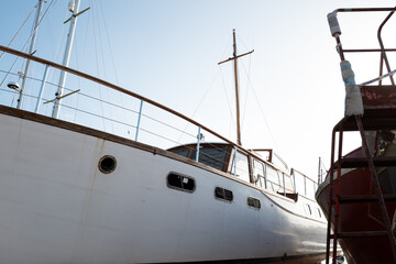 Large, bygone age cabin cruiser sale boat seen in dry dock at a marina in the east of England. The...