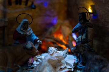 A nativity scene with Mary and Joseph kneeling over baby Jesus