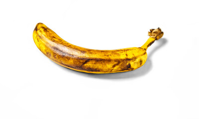 Rotten, overripe banana isolated on white background. Flat lay, selective focus. Food waste concept