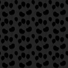 Repetitive pattern of black balloons on a dark background creating a minimalist design